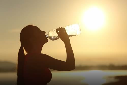 silhouette of a woman drinking water