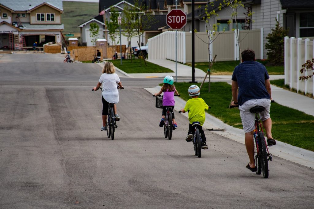 A family riding their bicycles on the street